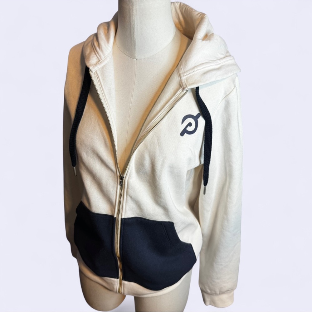 Peloton cream and navy blue hooded Jacket big logo on back beans new with tag